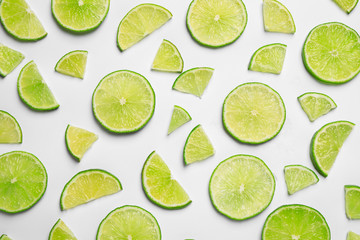 Juicy fresh lime slices on white background, top view