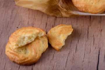 Homemade tasty cookies with parchment paper on the table.