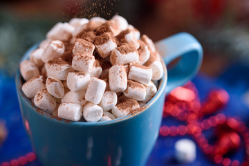 Aromatic coffee with marshmallow sprinkled with cocoa, New Year's and festive dessert and a drink.