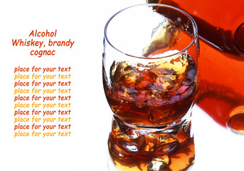 Glass and bottle of whiskey with splash on light background, selective focus on the glass