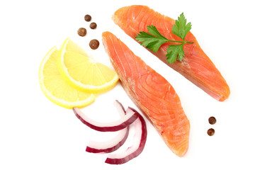 Red fish. Raw salmon fillet with parsley, peppercorns, onion slices and lemon isolate on white background. Top view