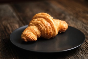 French croissant on the background of a wooden table 