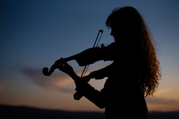 silhouette of girl with violin © Barry