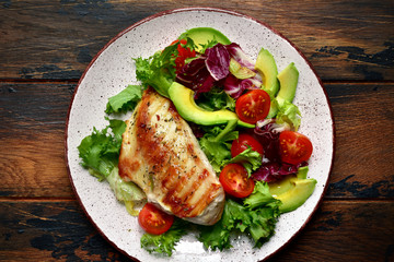Grilled chicken breast with vegetable salad. Top view with copy space.