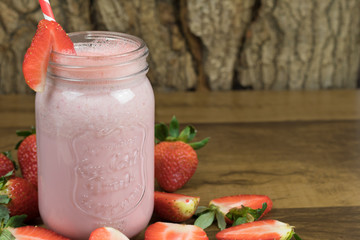 strawberry milkshake with wooden background
