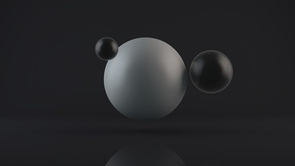 3D rendering of a large glowing white sphere and two black balls placed side by side. The objects are in a dark Studio. Abstract composition of ideal figures, a combination of white and black.