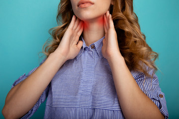 Sore throat concept. Closeup picture of woman holding her neck in pain