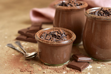 Homemade chocolate pudding in a vintage glass jars.