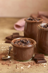 Homemade chocolate pudding in a vintage glass jars.