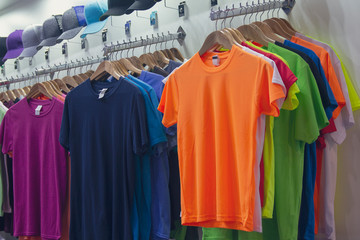 Colored T-shirts and caps in the sports store