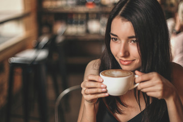 Beautiful woman drinking coffee sitting in a cafe.