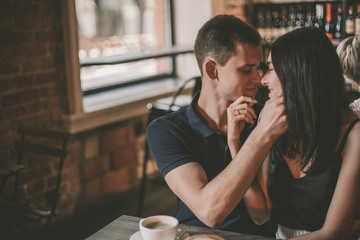 Loving couple hugging in the cafe.