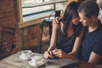 Loving couple hugging in the cafe.