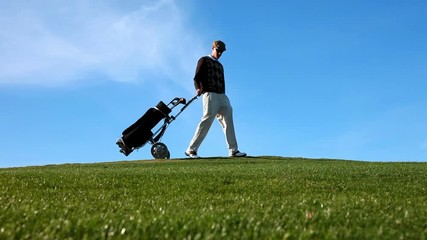 HD footage of a golfer on a golf course pausing to look at the camera while holding his club