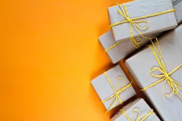Gift boxes wrapped in recycled paper tied with yellow twine, gift or delivery concept