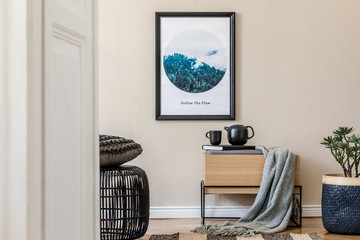Modern scandinavian living room interior with black mock up poster frame, design commode, rattan basket with plants, books, tea pot and elegant accessories. Template. Stylish home staging. Japandi.