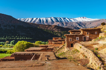View of adobe houses in the high snow-capped mountains in the Aït Bouguemez valley in Morocco