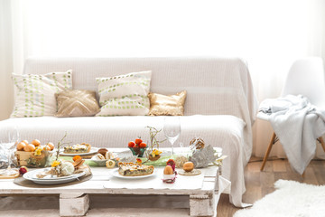 The interior of the room with a festive Easter table .