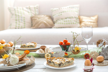 The interior of the room with a festive Easter table .