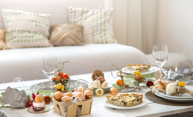 The interior of the room with a festive Easter table .