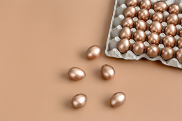 Background with Easter eggs in gold color.
