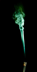 Green smoke swirling upward on a black background