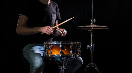 The drummer plays the drums. The process of playing a musical instrument. The concept of music.