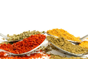 various spices. red pepper, black pepper and curry on white background