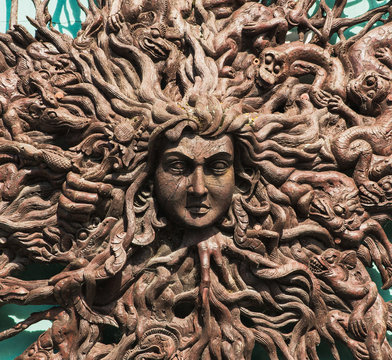 Cornwall, England, 03/09/19 Sculpture of the god medusa carved into nice dark wood with weather sealant on it protecting her from the elements. Nice artist rendition of the history god from mythology
