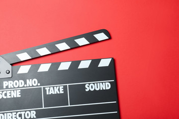 Fototapeta na wymiar Clapper board on red background, top view. Cinema production