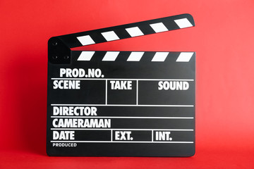 Fototapeta na wymiar Clapper board on red background. Cinema production