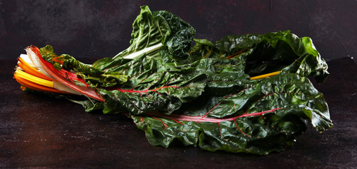 organic swiss chard in yellow, pink red and green. rainbow chard