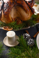 Fototapeta na wymiar Thanksgiving and holiday. Braised turkey on the served table. Vertical frame.