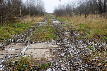 Rural gloomy cloudy foggy landscape with a road