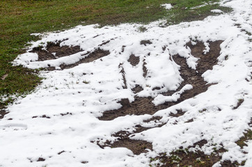 Frosty grass. Tractor trails through snow covered grass in winter