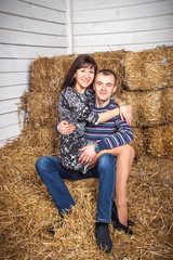 Naklejka na ściany i meble young girl with a guy lying on the hay