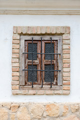 Barred Window with peeling paint in Ronda Spain