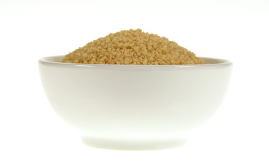 Couscous in bowl isolated on white