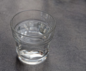 crystal clear glass of water on grey marble table background