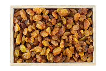 Raisins in a wooden box, isolated on white