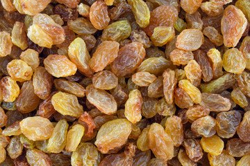Raisins macro shot. Full frame yellow raisins, top view.