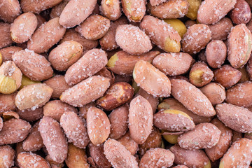 Salted peanuts macro shot. Full frame peanuts, top view.