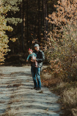 Happy loving family. Father and his daughter child girl playing and hugging outdoors. Cute little girl hugs daddy. Concept of Father's day