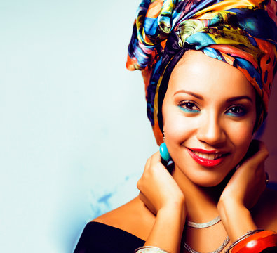beauty bright african woman with creative make up, shawl on head like cubian closeup smiling