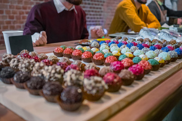 Assortment of colorful delicious fresh truffle cakes for sale on counter of shop, grocery, market, cafe or bakery. Dessert, sweet food and confectionery concept