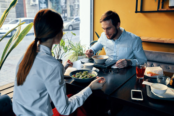 Man man and woman in a restaurant eating food