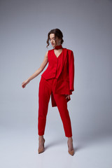 Beautiful young pretty woman bright evening makeup of shiny red lipstick brunette curly hair wear...