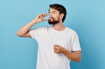 young man drinking a glass of water