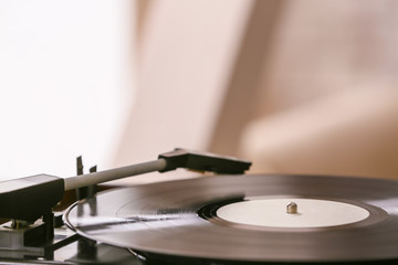 Record player with vinyl disc in room, closeup
