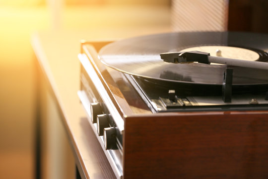 Record player with vinyl disc in room, closeup
